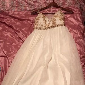 A long spaghetti strapped white and gold ball gown